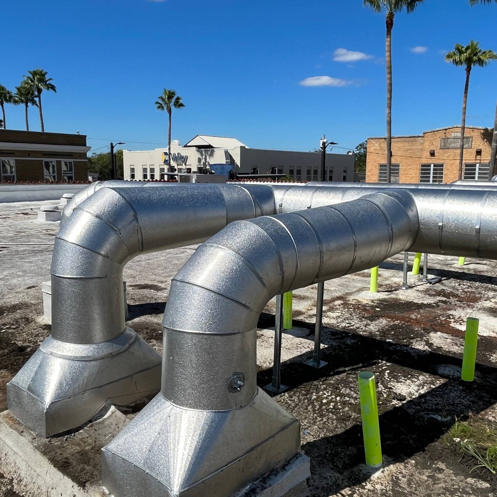 Metal-jacketed rooftop piping with elbows and roof penetrations