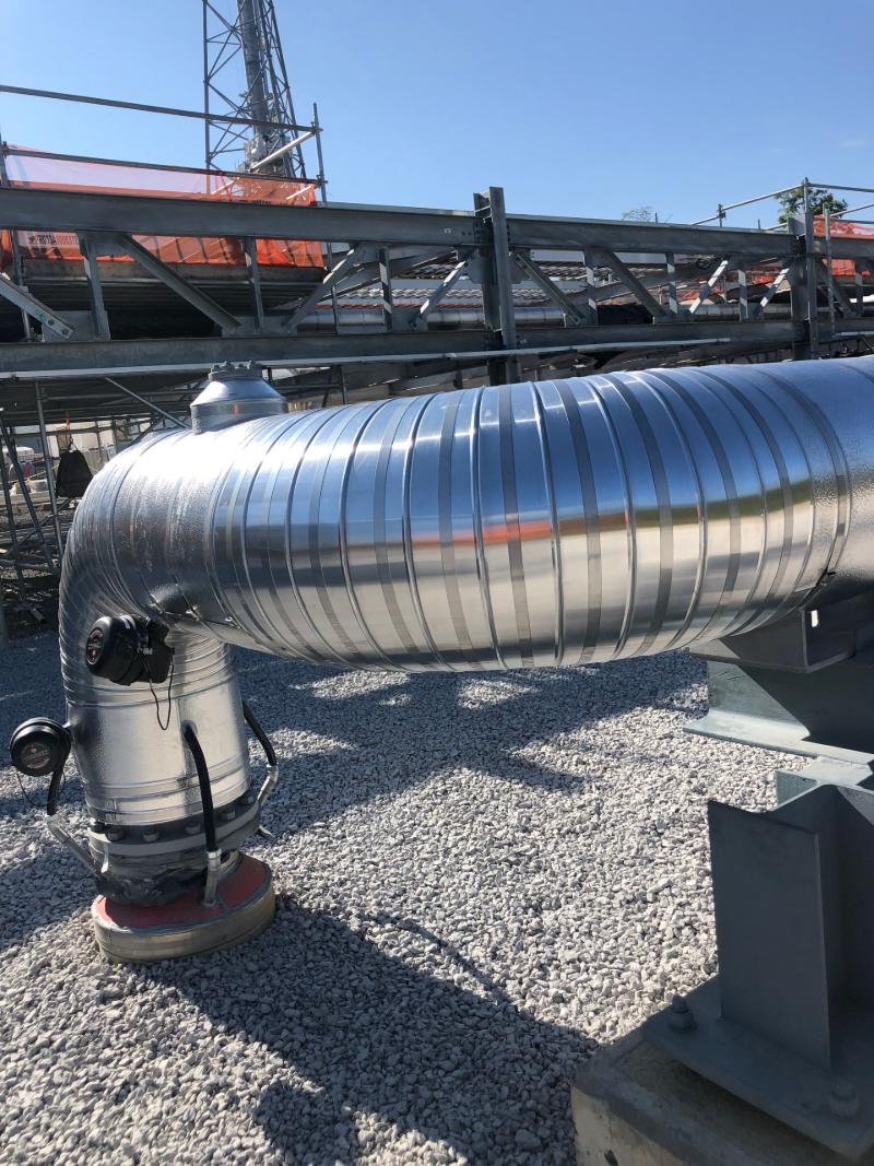 Metal jacketing around a large outdoor pipe run and elbow