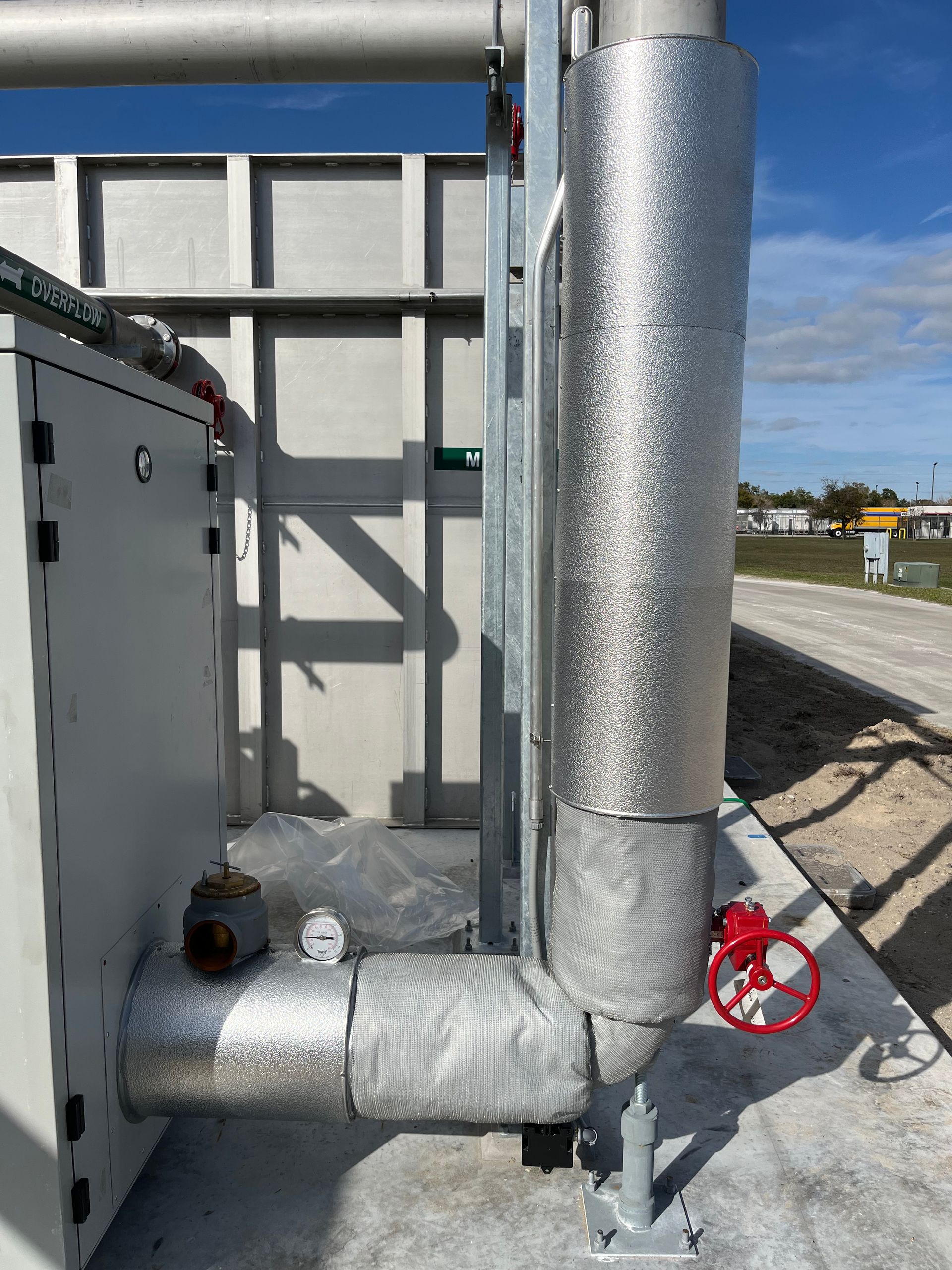Insulated chiller riser and valve on an outdoor commercial mechanical skid in Florida