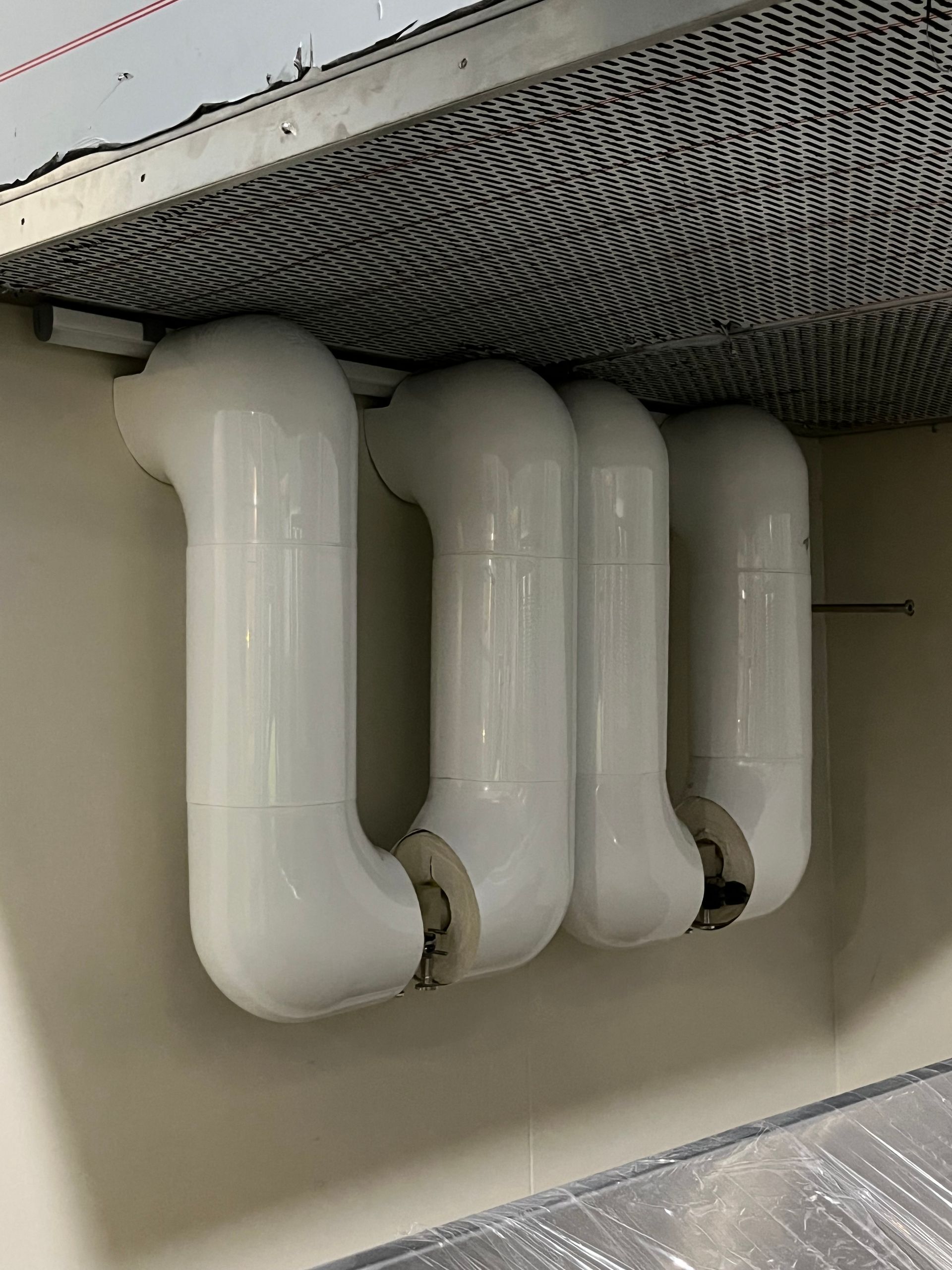 White PVC-jacketed pipe insulation on chilled process piping